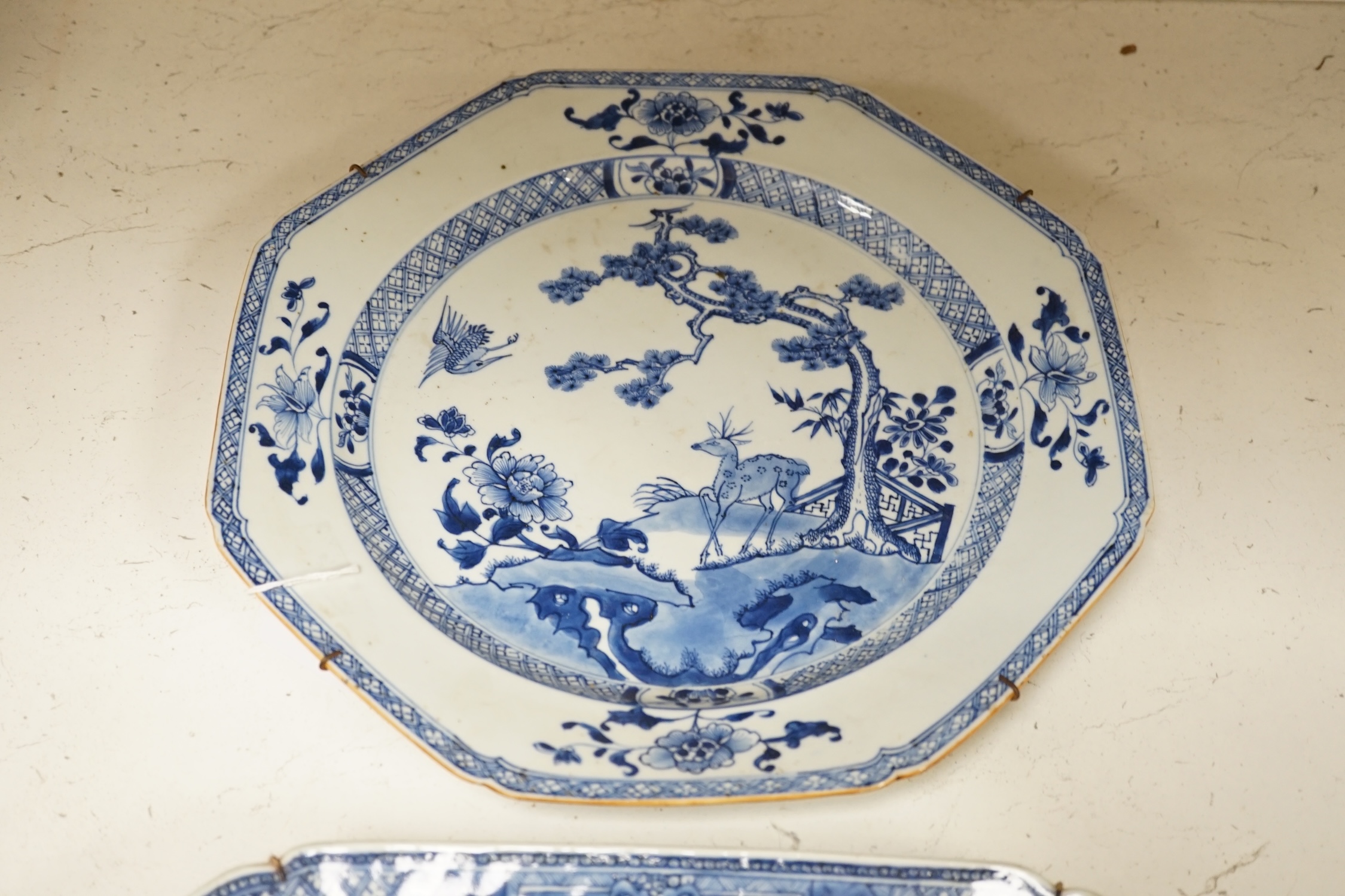 Two 18th century Chinese blue and white dishes, largest 44.5cm long. Condition - fair